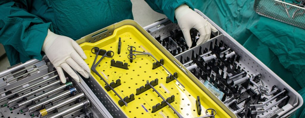 Zeigt bereitgelegte medizinische Werkzeuge aus Metall in einem Operationssaal